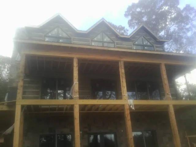 Dormers and porch framing on a large log home under construction in Burlington